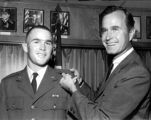 George H. W. Bush displays his son George W. Bush’s officer’s bar on his Texas Air National Guard uniform, circa 1968. Credit Getty Images
