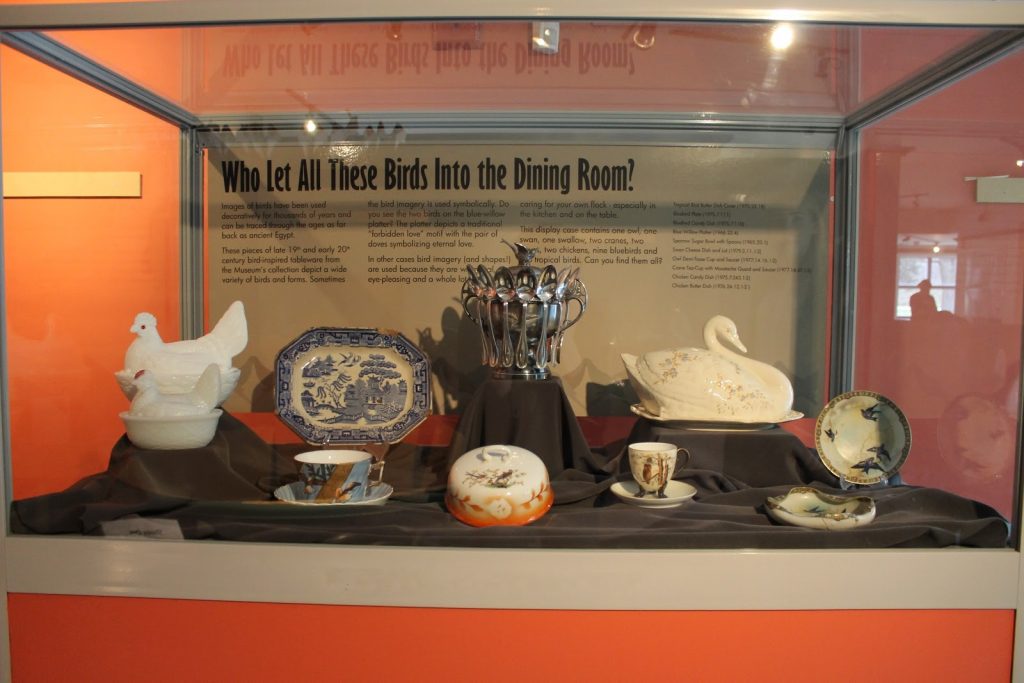 Display case with pottery and china inside.