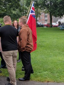 A group of people standing outside.