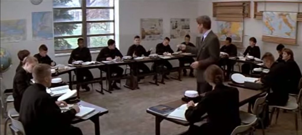 Harrison Ford as a History professor in Patriot Games. He is conducting a seminar, and pointing at students.