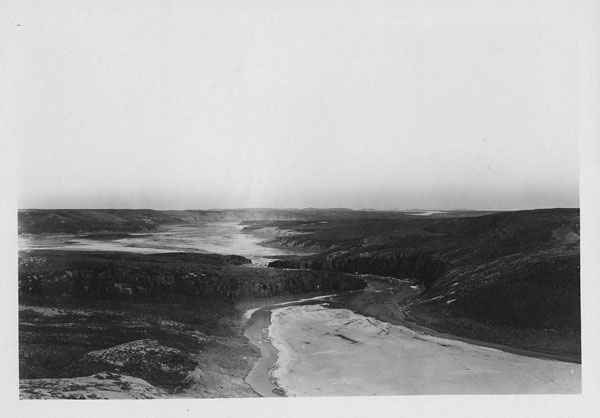 Panoramic black and white photo of a river.