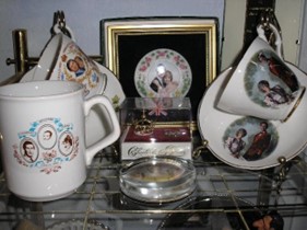 China cups and saucers with royal portraits on them.