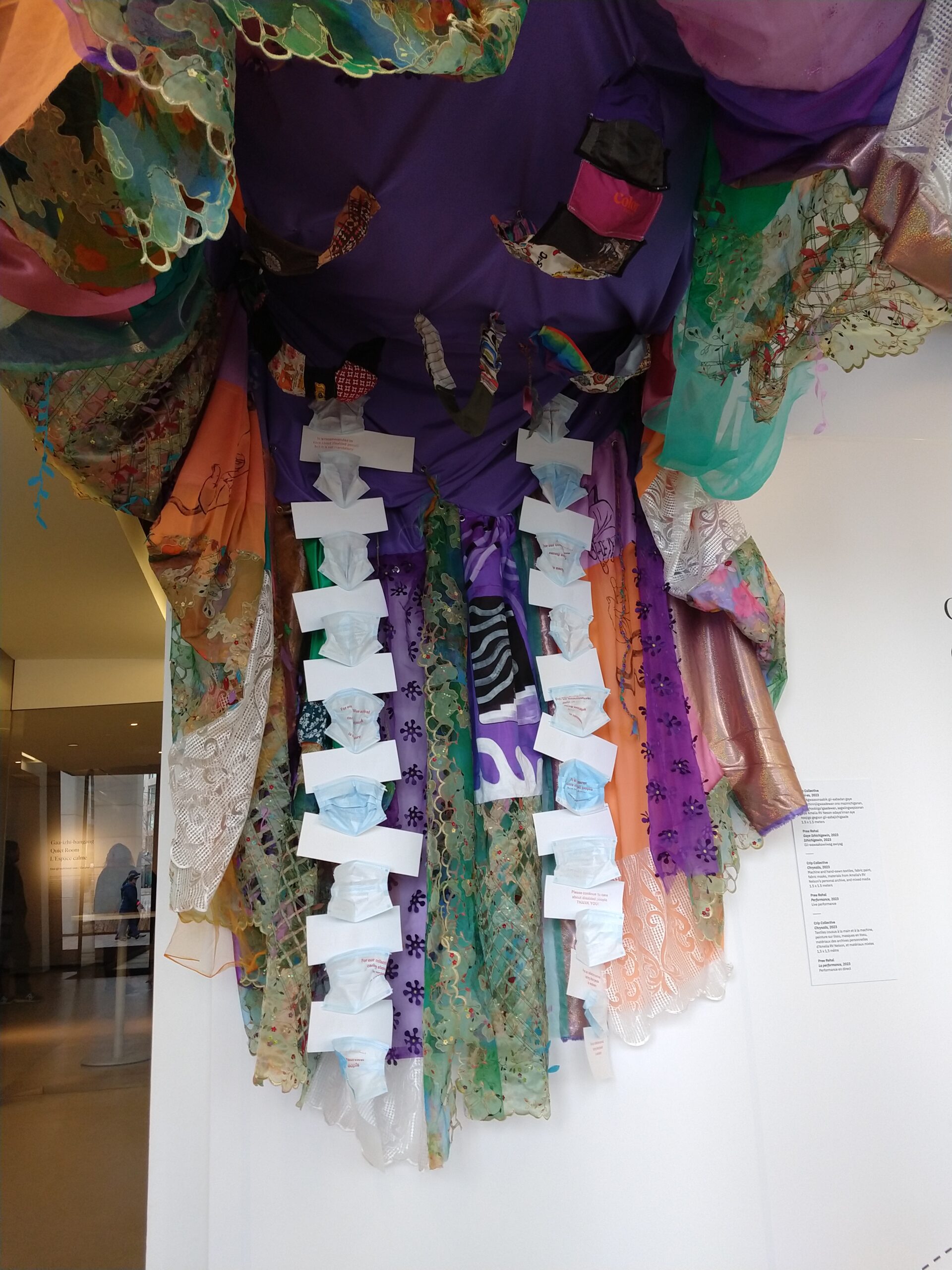 An art installation made of colourful fabric and paper face masks.