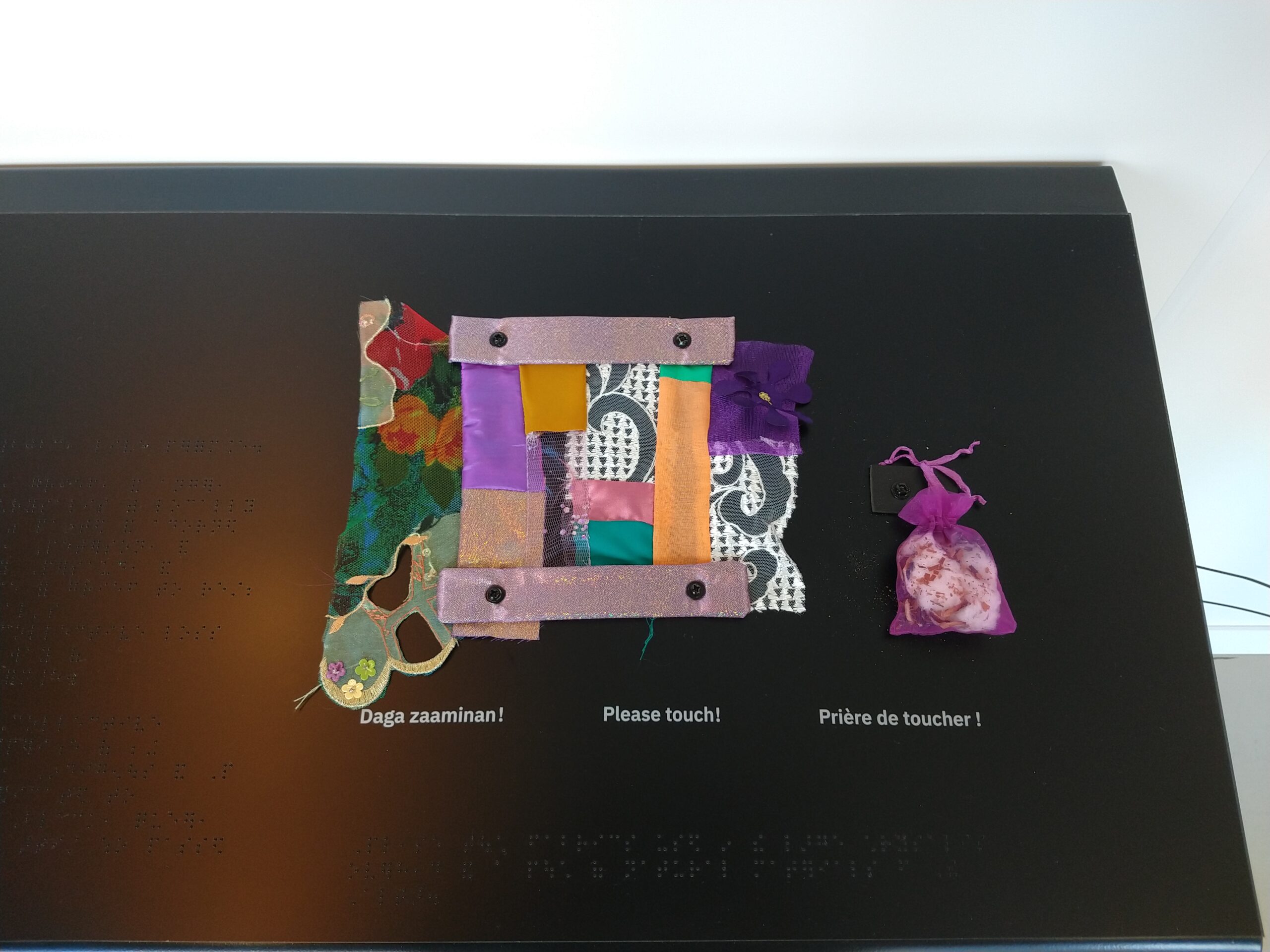 An art piece made of colourful fabric.