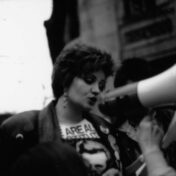 Black and white photo of a person speaking into a megaphone.