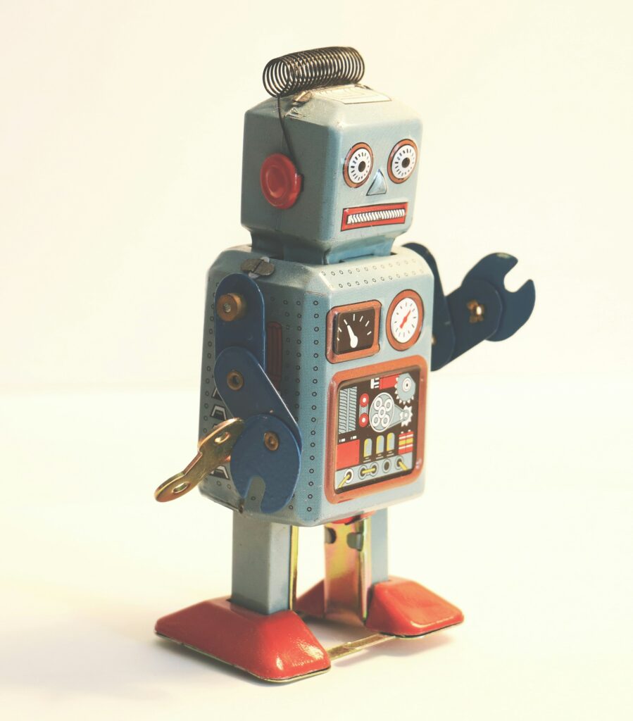 Photo of a grey and orange windup toy robot.