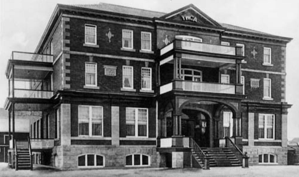 Black and white photograph of a large three-storey brick building.