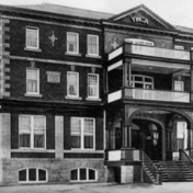 Black and white photograph of a large three-storey brick building.
